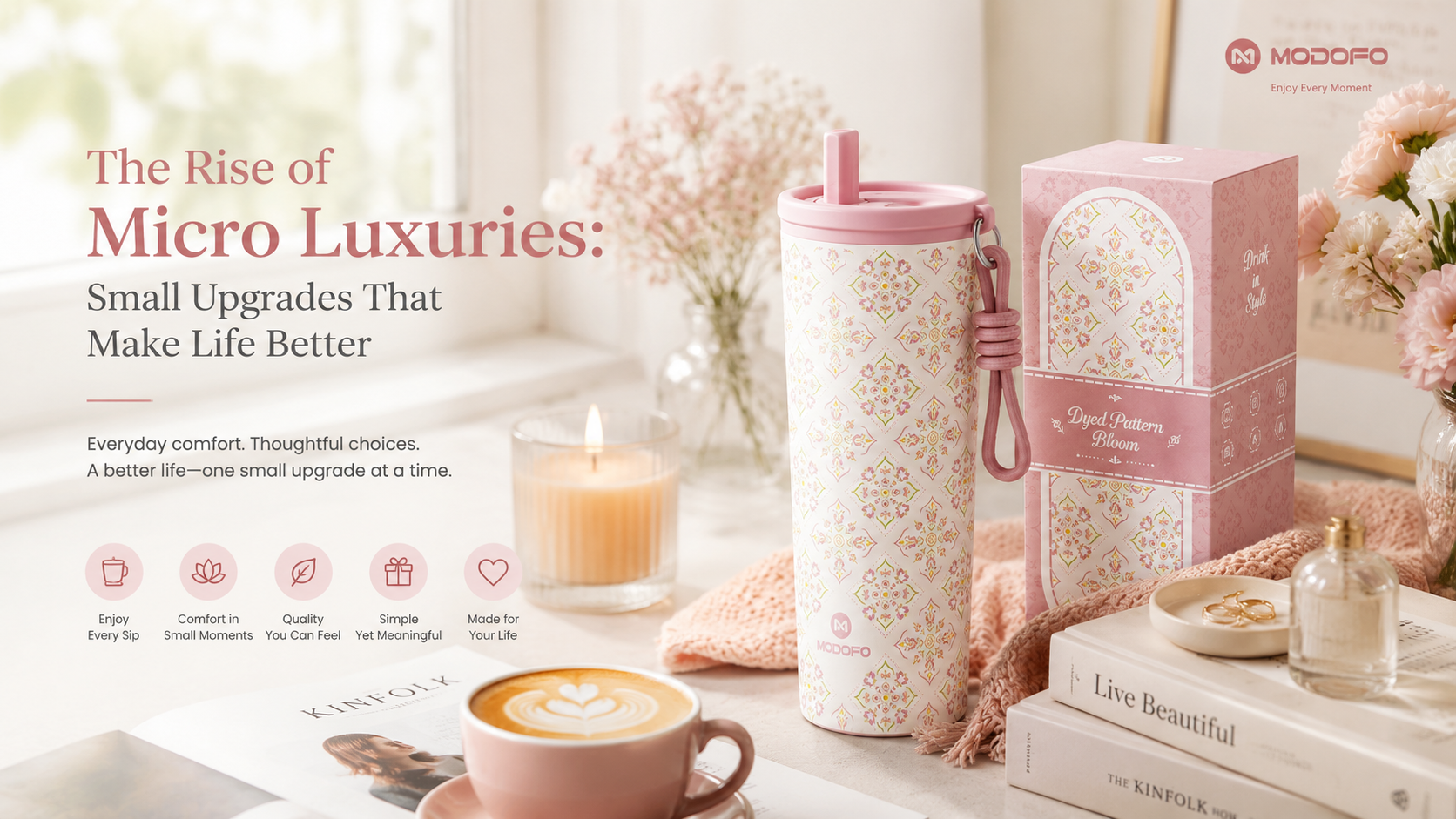 Modern lifestyle scene featuring an insulated tumbler, coffee, books, candlelight, and a cozy home environment representing the concept of micro luxuries and everyday comfort.